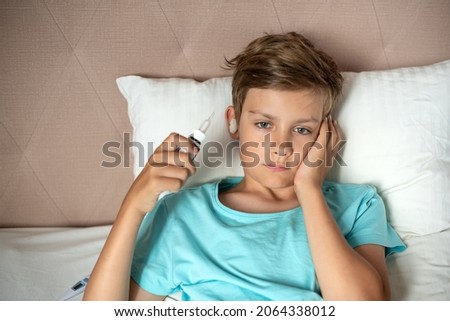 Children with a hand on ear has earache. Teen boy suffering from otitis,  Earache, Otitis media, acute ear pain, inflammatory disease of the middle ear Royalty-Free Stock Photo #2064338012