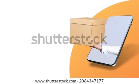 Getting online order concept. Ordering goods on mobile Internet. Box in hand next to phone. Application for ordering goods. Smartphone on white and orange background. Purchase online applications