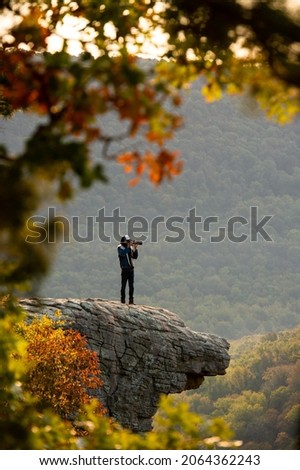 View of a photographer on Hawkbill Crag (Whitaker Point) in the Ozark National Forest near the Buffalo National River. Royalty-Free Stock Photo #2064362243