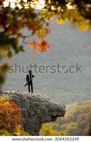 View of a photographer on Hawkbill Crag (Whitaker Point) in the Ozark National Forest near the Buffalo National River. Royalty-Free Stock Photo #2064362249