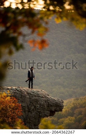 View of a photographer on Hawkbill Crag (Whitaker Point) in the Ozark National Forest near the Buffalo National River. Royalty-Free Stock Photo #2064362267