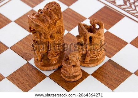 Indian sandalwood chess pieces on a board