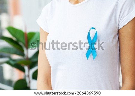 Woman with blue ribbon, prostate cancer awareness