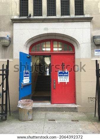 Voting signs in front of an entrance to a polling place at a public school in New York City on Election Day