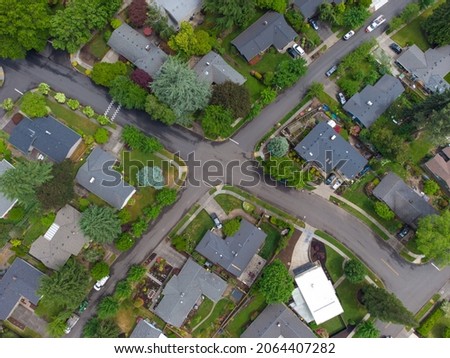 Small town, residential neighborhood. A lot of greenery. Asphalt roadways, footpaths. There are no people in the photo. Beautiful scenery. Top view. Aerial view.