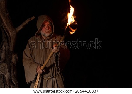 Angry farmer with torch in the middle ages  Royalty-Free Stock Photo #2064410837