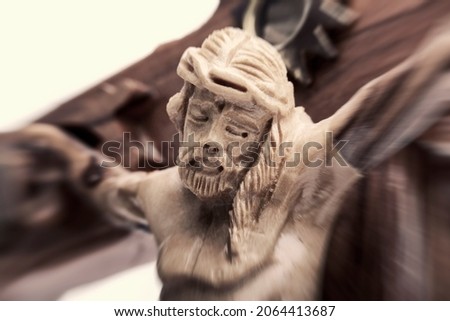 Holy wooden cross with crucified Jesus Christ close up, motion blur effect