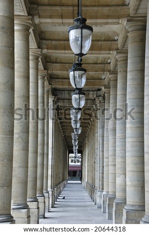 Row of ceiling lamps flanked by columns lined in parallel