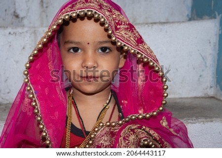 girl kid cute facial expression in marriage ceremony dress from unique low angle shot in details Royalty-Free Stock Photo #2064443117