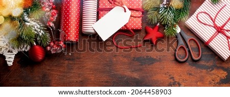 Christmas gift boxes packaging, paper rools, decor and fir tree. Top view flat lay