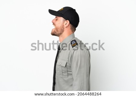 Young security Brazilian man isolated on white background laughing in lateral position