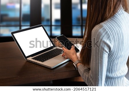 women working laptop and on the white table at home office. in morning light 
