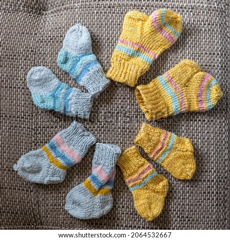 photography with beautiful, variegated small children's socks, handmade, wool yarn, knitted texture