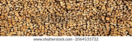 Panoramic view of a stack of firewood stowed and ready for winter use 