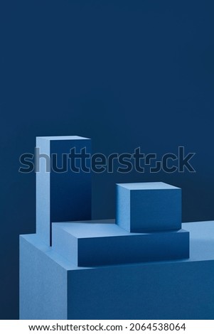 Front view of blue square podium in blue background and shadow with blank space for advertising 