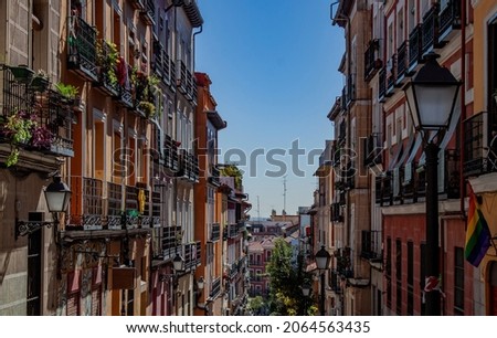 Exterior view of beautiful historical buildings in Madrid, Spain, Europe. Colorful Mediterranean urban street in the former Jewish quarter, Lavapiés, Embajadores neighborhood of the Spanish capital. Royalty-Free Stock Photo #2064563435
