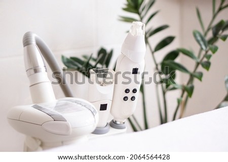 Closeup  vacuum roller massage apparatus for face and body  on medical cabinet background with copy space. LPG for face lifting. Royalty-Free Stock Photo #2064564428