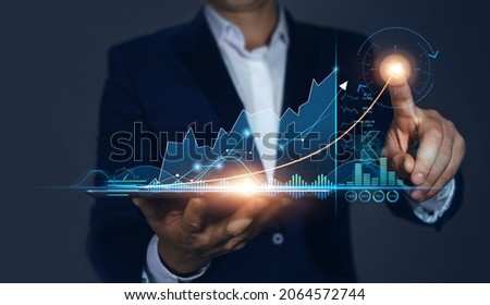 Businessman Holding Tablet and draws  Growing Virtual Hologram of Statistics, Graph and Chart. Business Strategy Development and Growing Growth Plan.