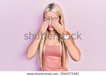 Young blonde girl wearing casual clothes rubbing eyes for fatigue and headache, sleepy and tired expression. vision problem 