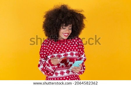 beautiful hispanic latin woman, christmas, shopping online yellow background