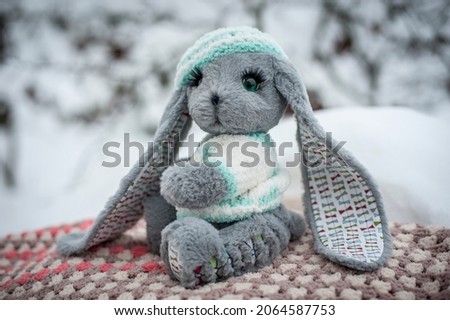 soft toy hare on the background of snow