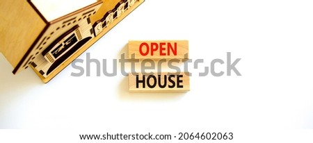 Open house symbol. Concept words 'Open house' on wooden blocks near miniature house. Beautiful white background, copy space. Business and open house concept.