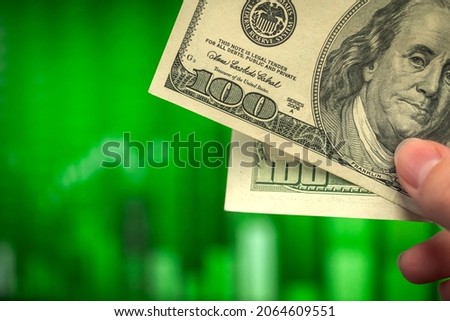 Close-up US money. Trading graph and green candlestick chart on a backgroud. Financial investment, economy trends, business idea photo