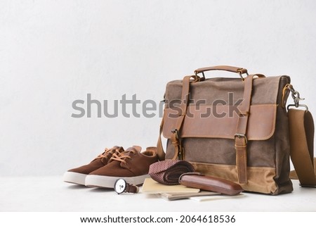 Set of stylish male accessories on light background Royalty-Free Stock Photo #2064618536