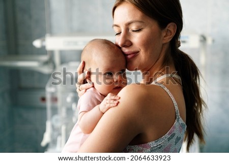 Happy cheerful family. Mother and baby kissing, laughing and hugging
