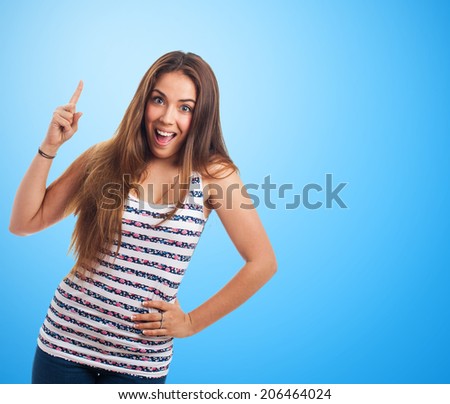portrait of a young woman pointing up