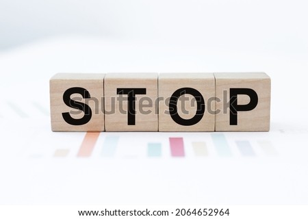 Four wooden cubes with letters stop. Business marketing concept.