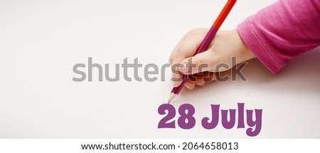 A child's hand writes 28 july in lilac pencil. Banner with copy space