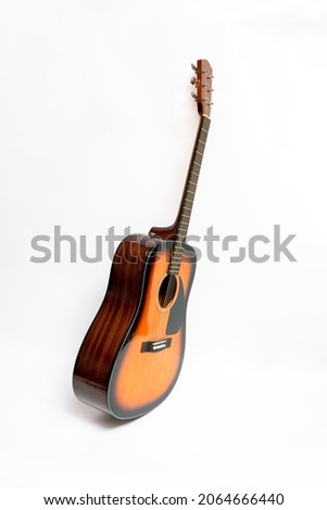 Brown guitar on white background.