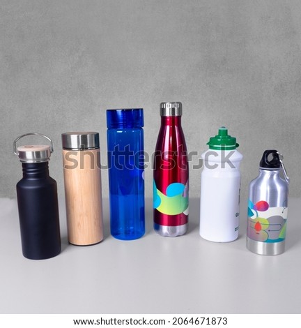 Collection of thermo bottles- and thermos tea-coffe-plastic bottles for sports-Different colors-aluminum-texture-Promo products.Copy space