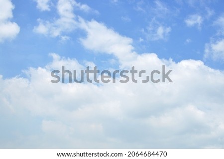 light blue cloudy skies on a sunny day