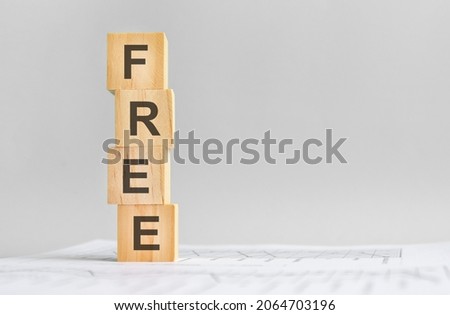 word Rent with wood building blocks, light gray background. document with numbers on background, business concept. space for text in left. front view