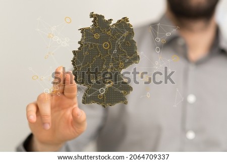 A human hand showing a map of Germany consisting of 3D triangles, lines,