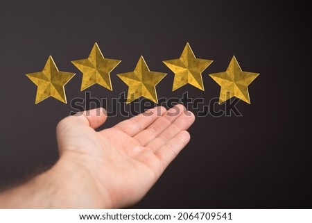 A customer hand touching to yellow illustration 5 stars virtual screening monitor for satisfaction evaluation