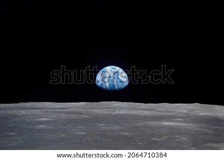 The 'Earthrise' seen from the Moon. Digital Enhancement. Elements of this image furnished by NASA Royalty-Free Stock Photo #2064710384