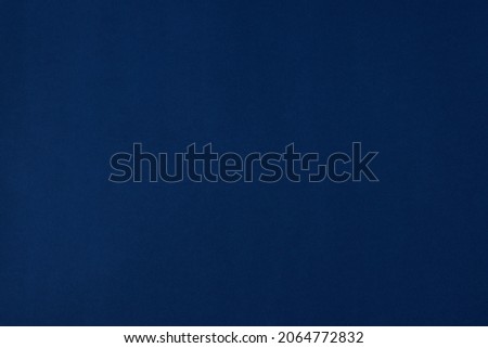 dark blue background, sheet of colored textured blue craft paper, top view, pantone 2021-2022. solid deep blue color