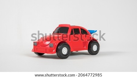 Small passenger car. Plastic toy multicolored cars isolated on white background.
