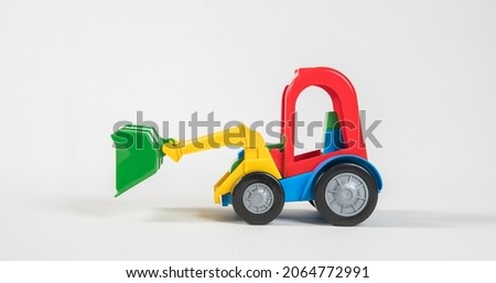 Excavator. Plastic toy multicolored cars isolated on white background.