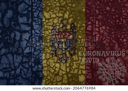 flag of moldova on a old vintage metal rusty cracked wall with text coronavirus, covid, and virus picture.