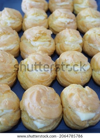 kue sus or the arrangement of choux pastry with vanilla cream as filling. blurry or selective blurred