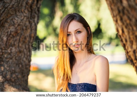 Close up portrait of young teenager outdoors in a park. Filtered image. 