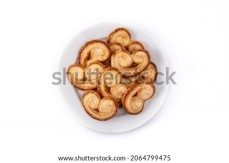 Palmier puff pastry in white plate isolated on white background