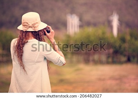 Woman taking photo in vintage style processing