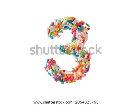 Multi color sugar sprinkles number 3 on white background