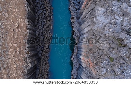 top down of studlagil canyon, extraordinary canyon with blue glacial river Royalty-Free Stock Photo #2064833333
