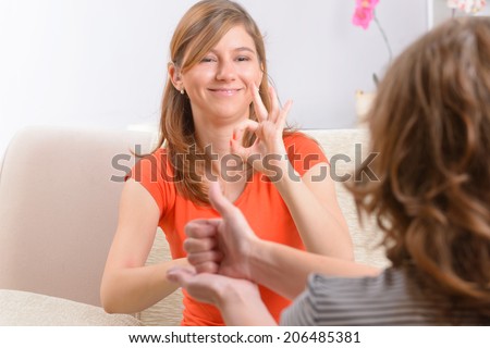 Smiling deaf woman learning sign language